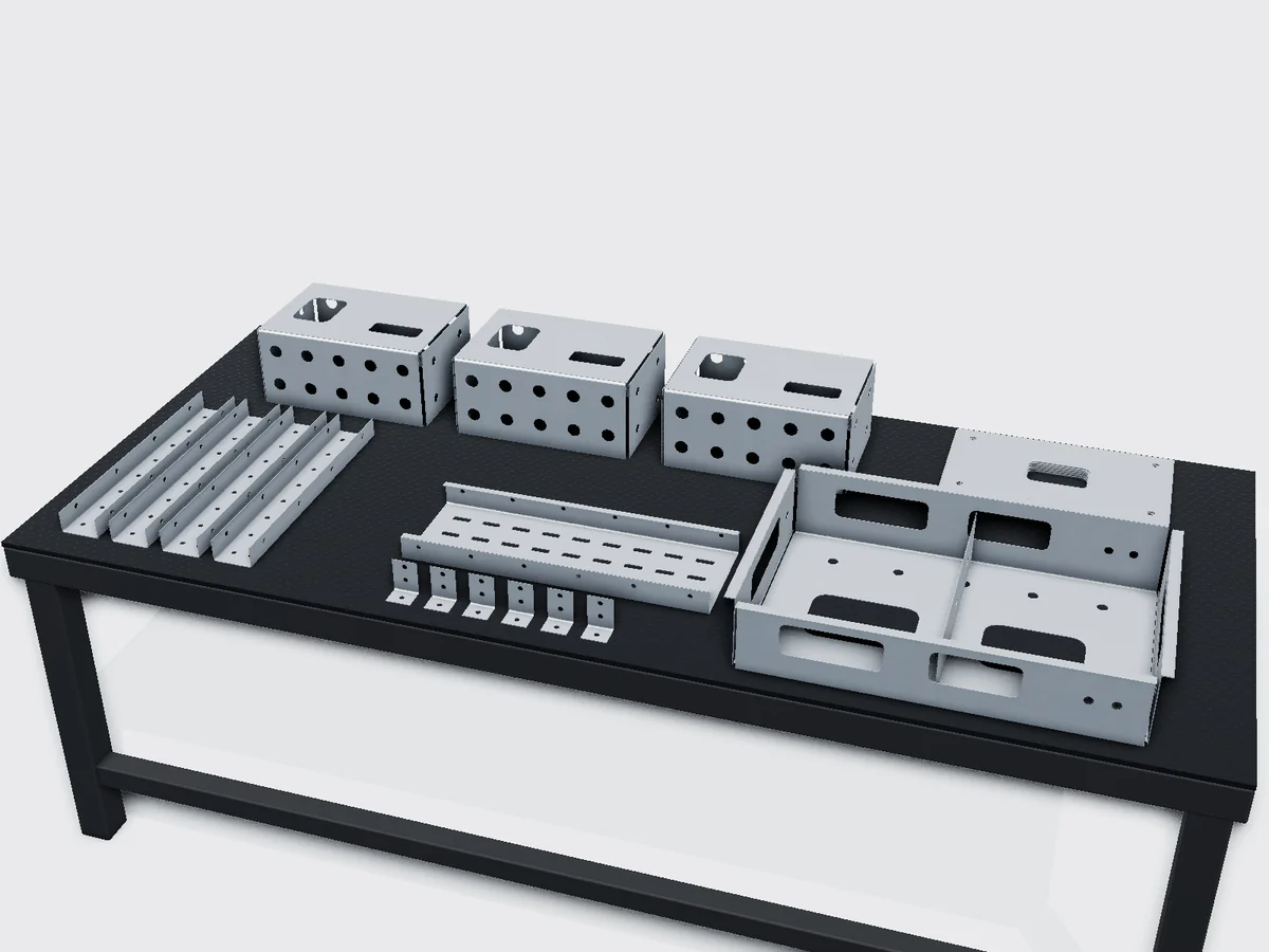 Galvanised sheet metal fabrication on a workbench: batch of punched covers, welded chassis with cut-outs, perforated trays, U-brackets, L-brackets and laser-cut blanks on a workbench